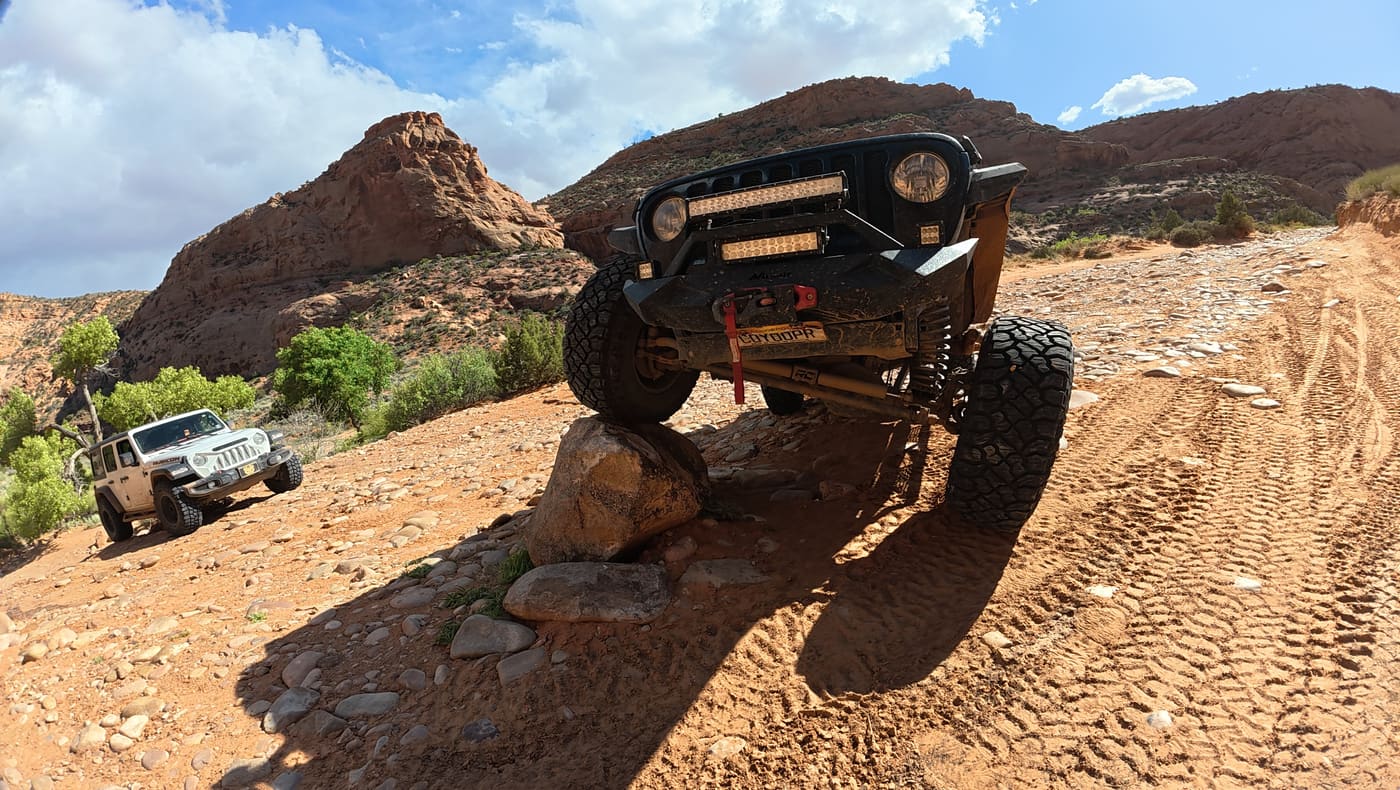 Sucia flexing over a rock obstacle in Moab